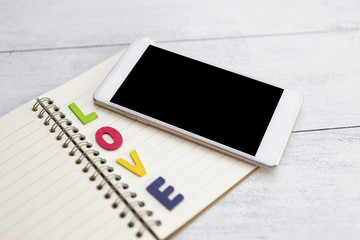 New smartphone over love notebook
