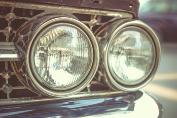 Classic car with close-up on headlights or Headlight lamp of retro  car vintage style