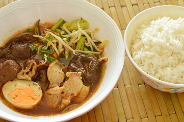 boiled pork entrails topping egg in brown soup eat couple with rice