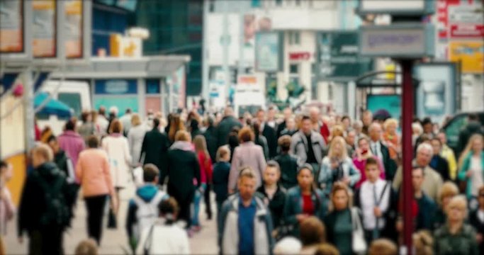 Crowd of People / Commuters Walking / Busy Street. Crowd on a busy street. People walk down a busy street with advertising, billboards, cars and public transport. Slow motion.