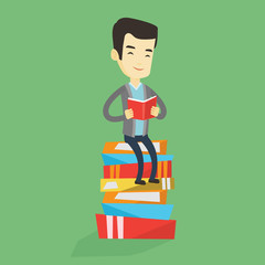 Student sitting on huge pile of books.