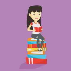 Student sitting on huge pile of books.