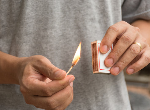 This guy using matchsticks rubbing against the side of the box matches, causing fire.