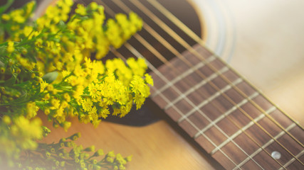 Morning relaxation and cozy with small yellow flower on guitar in vintage tone  for Rural vacation lifestyle , music therapy concept