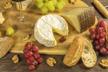 Cheese, bread and grapes at wine tasting