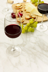 Wine tasting with bread, grapes, cheese, and copyspace