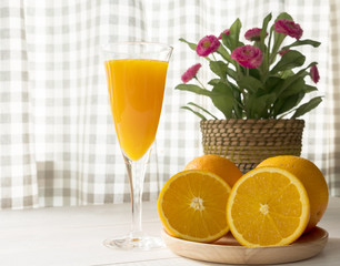 Fresh orange fruit and orange juice on white table