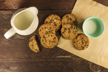 Chocolate chips cookies on baking paper, with milk