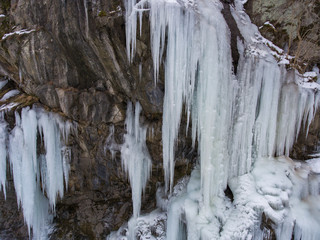 Fototapeta na wymiar Aerial Photos. Large icicles hanging from the cliff.
