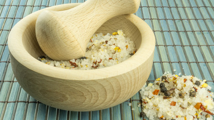 Steak salt in a wooden mortar on a wood background