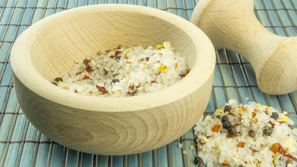 Steak salt in a wooden mortar on a wood background