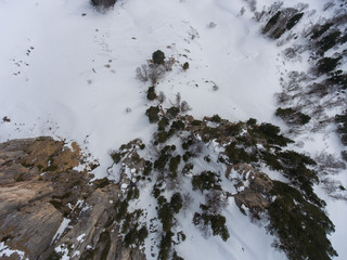 Aerial landscape. Rocky plateau and snow covered forest..