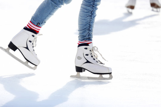 feet skating on the ice rink.