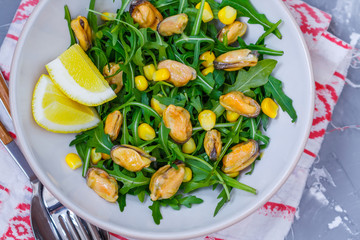 Fototapeta na wymiar Salad with mussels and corn, diet, vitamin snack.