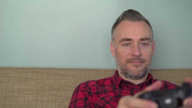 A man enjoys playing a video game