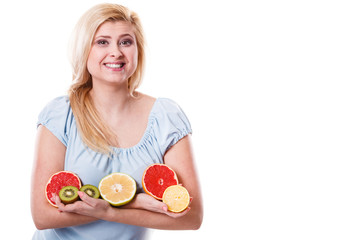 Woman holding fruits kiwi. orange, lemon and grapefruit