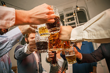 Group of friends enjoying evening drinks with beer