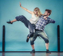 couple of young man and woman dancing hip-hop