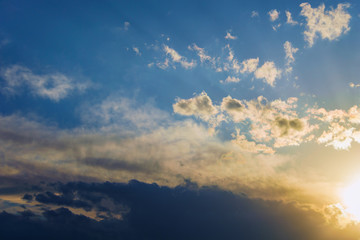 Naklejka na ściany i meble background of sky, the sunlight streaming through dramatic clouds