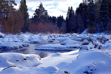 Beautiful small river in winter forest.