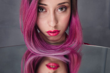 Young woman model with pink hair and make-up