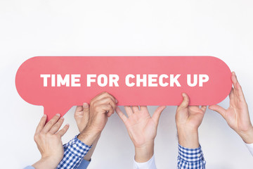 Group of people holding the TIME FOR CHECK UP written speech bubble