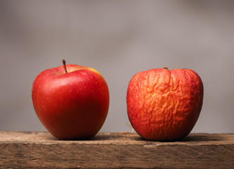 Two red apples on table