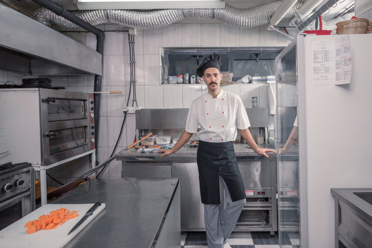 chef posing, looking at camera, commercial kitchen