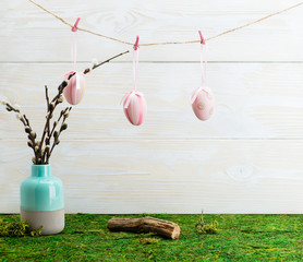 Easter hanging eggs over wooden background. View with copy space