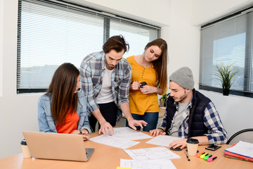 Obraz premium group of young cool hipster creative business people in casual wear working together in meeting room of a startup company