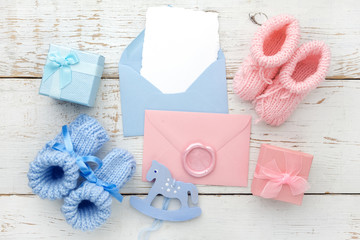 Set of baby girl and boy booties and greeting card form. Top view