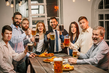 Group of friends enjoying evening drinks with beer