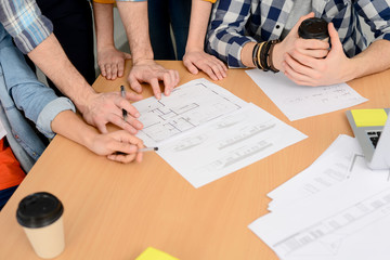 hands close-up group of young cool hipster creative business people in casual wear working together in meeting room of a startup company