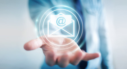 Businessman holding 3D rendering flying email icon in his hand © sdecoret