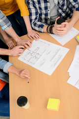 hands close-up group of young cool hipster creative business people in casual wear working together in meeting room of a startup company