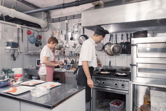 two people, chef cooking food, commercial kitchen