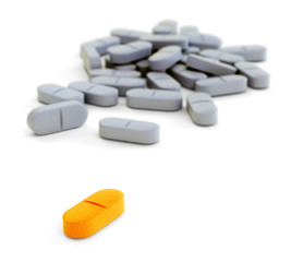 Orange and gray pills on white