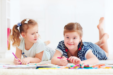 happy young girls, kids painting with felt pen together