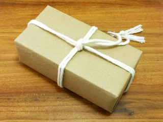 gift box wrapped in recycled paper with white rope
