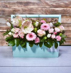 Beautiful flowers in a turquoise wooden box