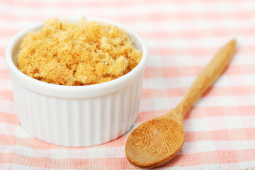 dried pork floss in white cup with wooden spoon