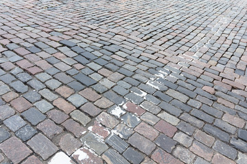 Old paving stones and remnants of road markings. Backgrounds and textures