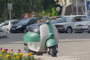 Retro scooter parked on a city street. Transport