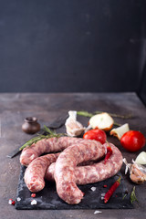 Raw sausages on slate