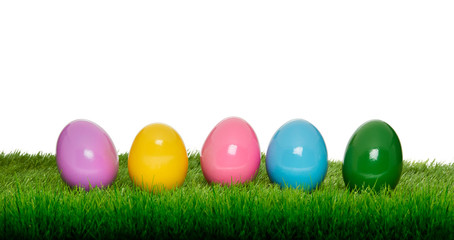 Colourful painted Easter Eggs on green Grass and white copy space background.