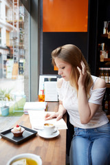 A shot of a beautiful asian woman drinking coffee in a cafe