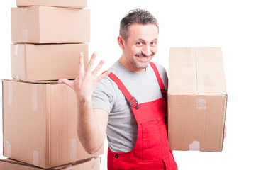 Portrait of mover man holding box showing five gesture