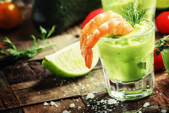 Shrimp and avocado, old wooden background, selective focus