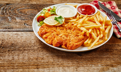 Schnitzel served with fired potatoes