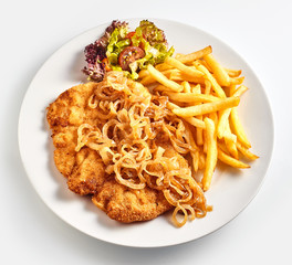 Wiener Schnitzel with onion and French fries